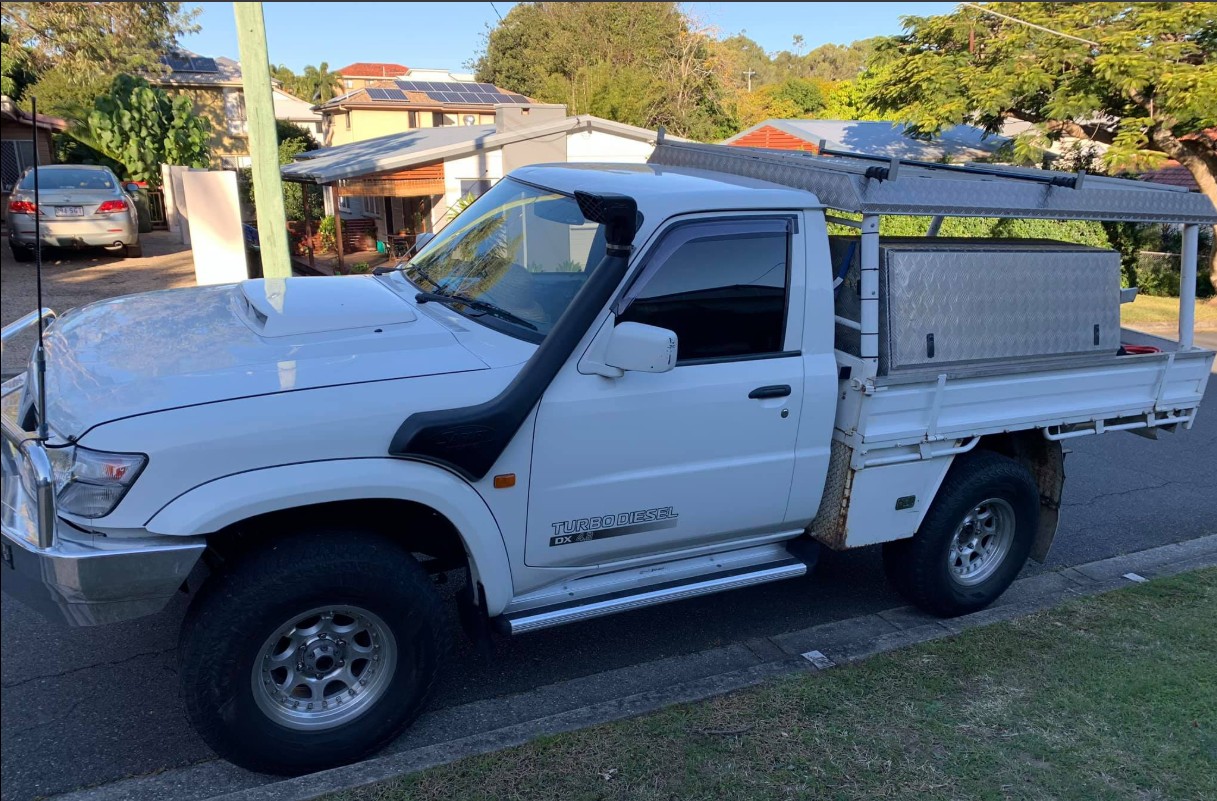 White Nissan Patrol 4WD with mobile-installed tint